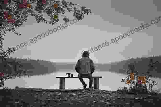 A Person Sitting On A Bench, Looking Out At A Lake. Life After Loss: The Lessons Of Grief